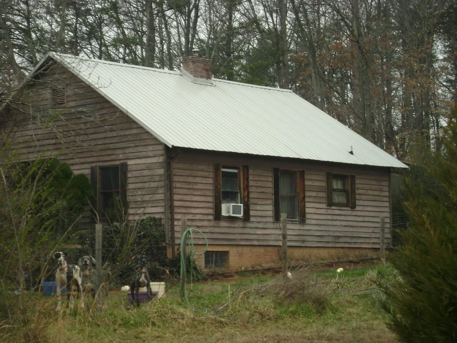 White metal roof on an old wood sided farmhouse, from a Asphalt Shingle Roof Repair job in Burtonsville